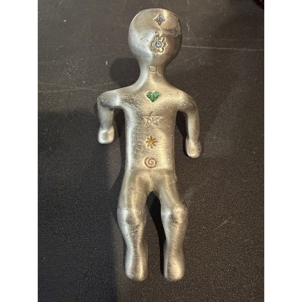 Sitting Back Metal Human Figurine with Symbols